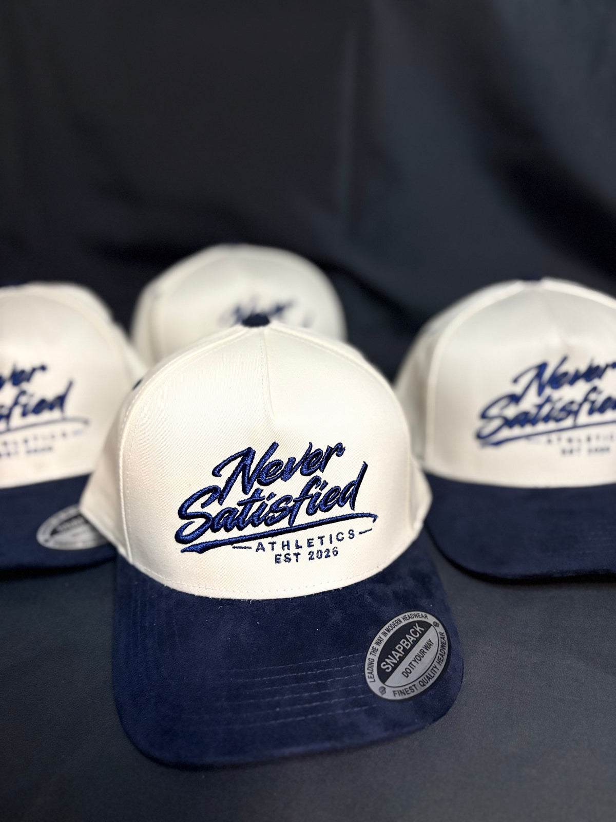 NSA CREAM AND NAVY BLUE CURSIVE SUEDE SNAPBACK.